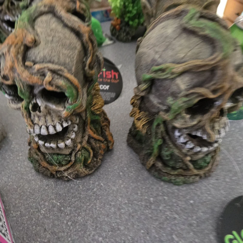 Decorative Skull Figurines with Green Accents
